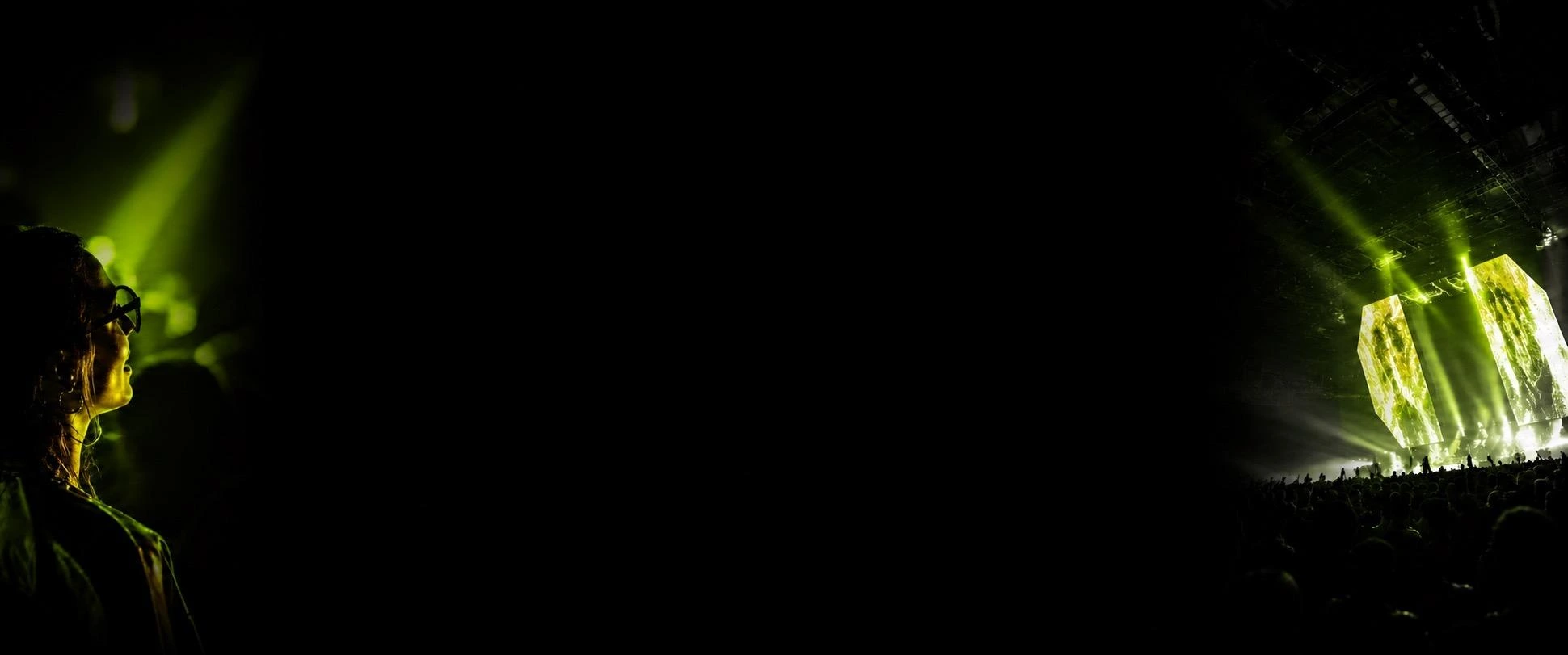 An audience member and an illuminated stage from the SCENE portfolio